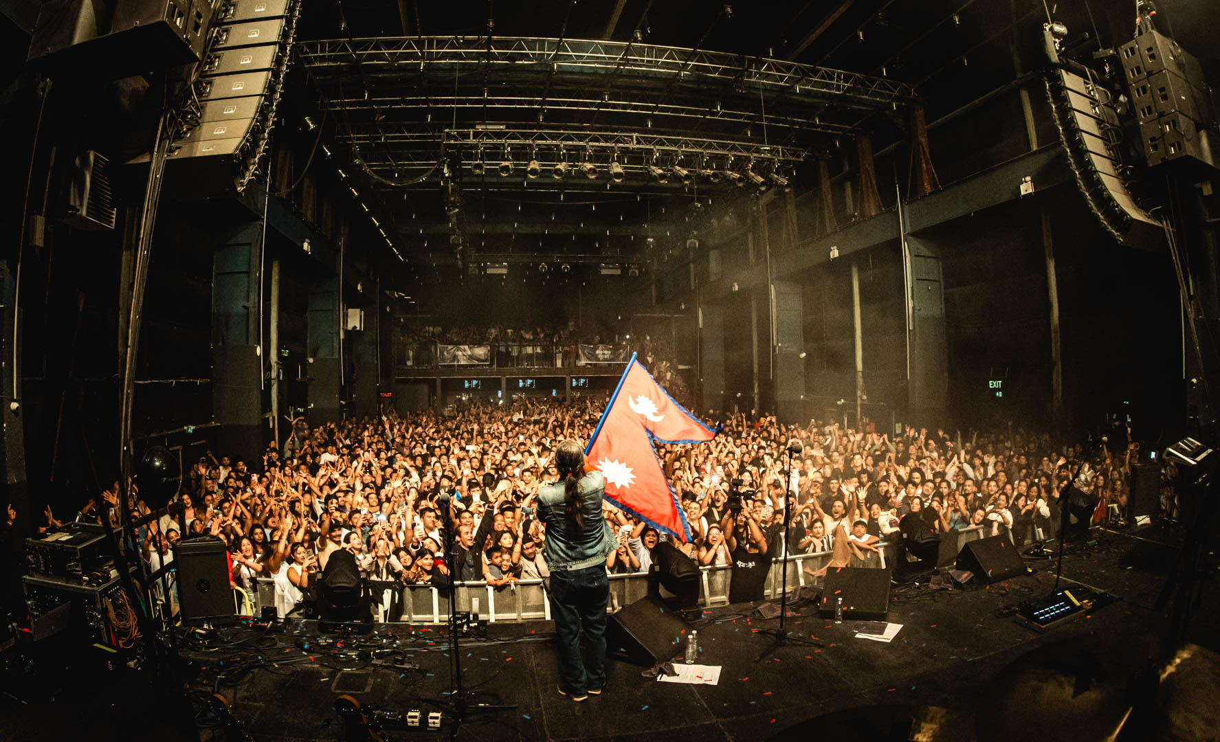 02-Nepathya-frontman-Amrit-Gurung-waves-Nepali-flag-at-the-concert-in-Copenhagen.-Photo-Dipit-Raz---nepalaya-1756190585.JPG